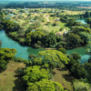 An aerial view of Carmelita Gardens in Cayo Belize, highlighting the Belize River