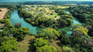An aerial view of Carmelita Gardens in Cayo Belize, highlighting the Belize River