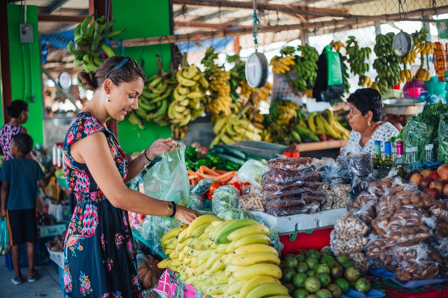 Woman gathering fruits and legumes at the San Ignacio Market, at the Welcome Center, in Cayo, Belize.in Cayo