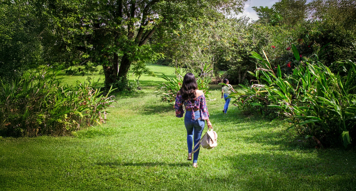 Two women exploring the greenery in Cayo, Belize.