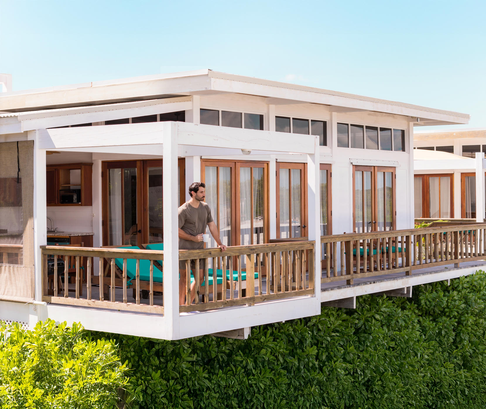 Man looking our his balcony at Aruna Resort and Villas. Click here for more on Aruna. Man looking our his balcony at Aruna Resort and Villas. Click here for more on Aruna.